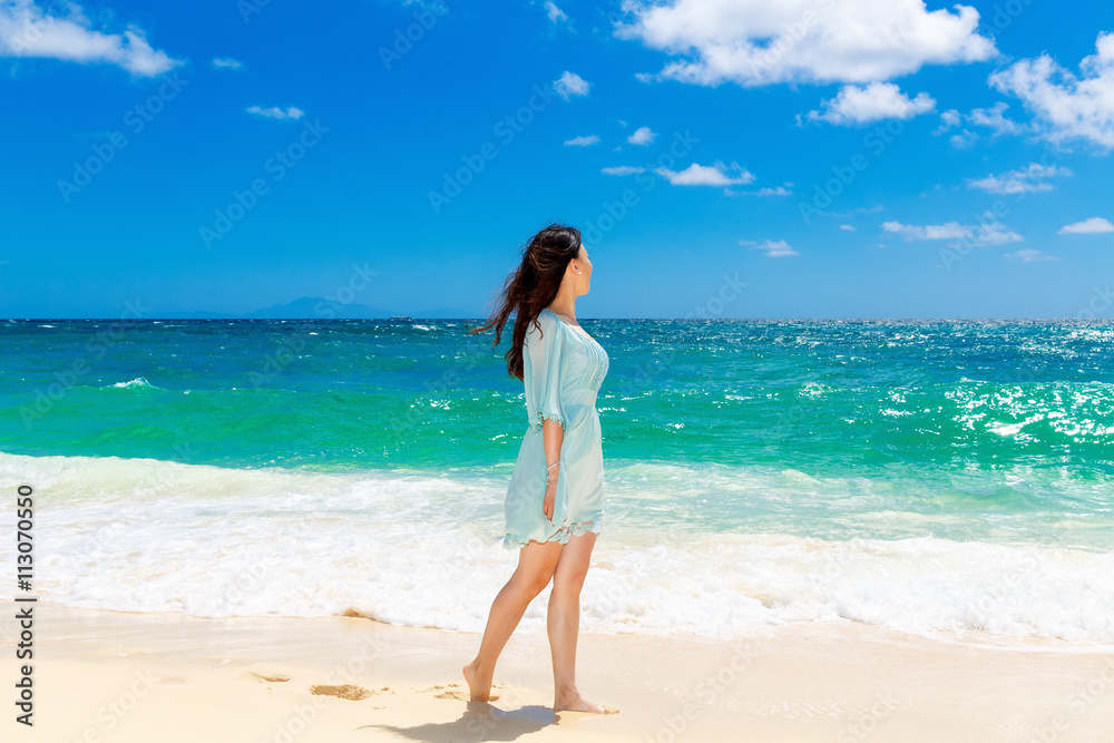 Young beautiful Asian girl on the tropical beach Young beautiful Asian girl on the tropical beach