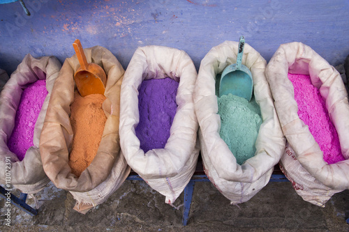 Africa, North Africa, Morocco, Chechaouen,containers of colorful pigments,powders or dyes on historical village street. photo