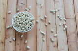 Pistachio in white bowl on wood background