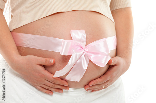 Wallpaper Mural Pregnant woman with pink ribbon over her belly. Hands on tummy. Frontal view, horizontal shot Torontodigital.ca