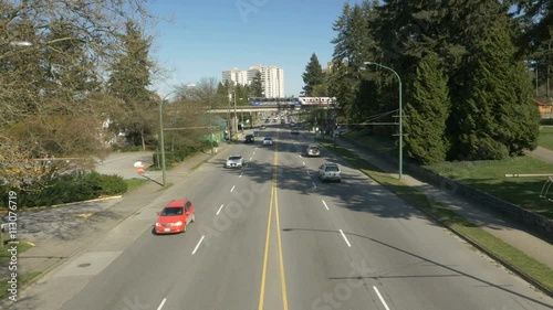 City view of road with cars and skytrain photo