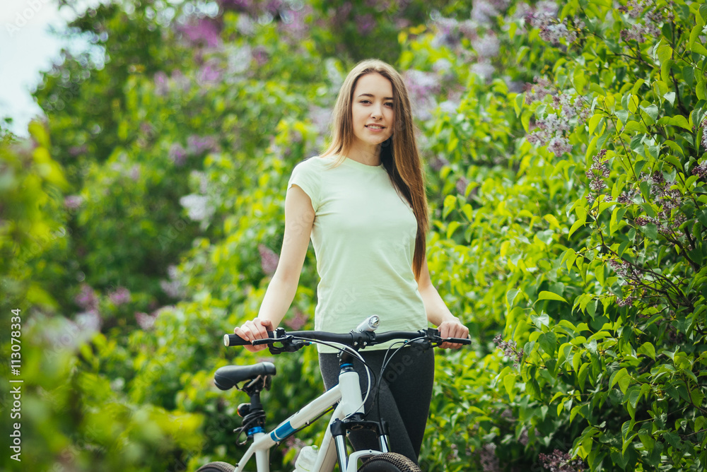 Happy young girl cyclist standing with a mountain bike and. Adventure travel. Happy young girl cyclist standing with a mountain bike and. Adventure travel.