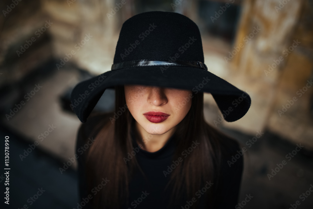 Street portrait of young casual lady in hat, black clothes, red lips Street portrait of young casual lady in hat, black clothes, red lips