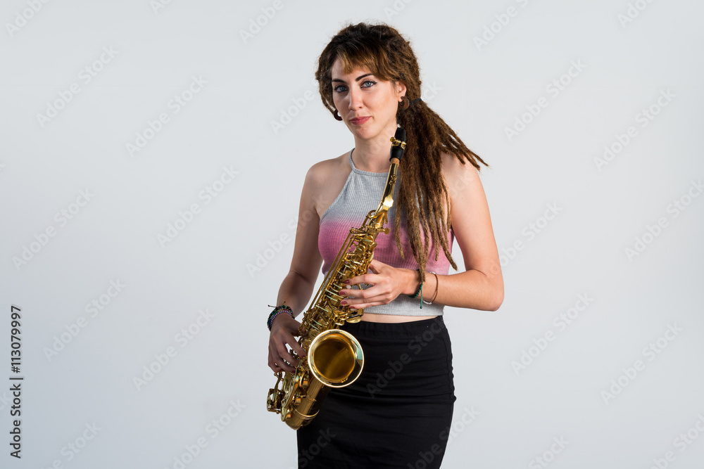 Naklejka premium Girl with dreadlocks playing the saxophone