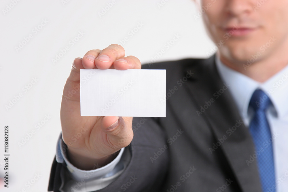 Close-up of business card in business mans hand Close-up of business card in business mans hand