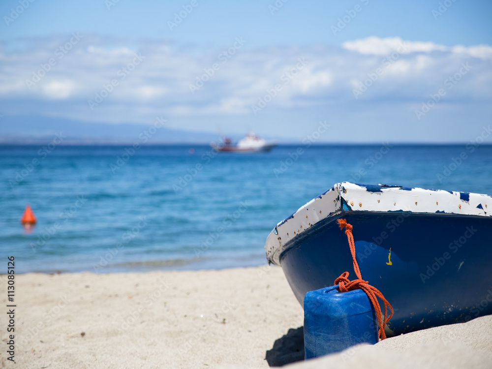 navy boat on a white sand beach and turqouise sea navy boat on a white sand beach and turqouise sea