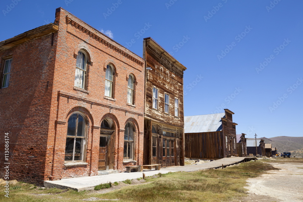 Brick Post Office and Dechambeau hotel, next to the wooden IOOF or Bodie Odd Fellows Lodge, a masonic lodge dating from 1878, on Main Street in the gold mining ghost town of Bodie, Bodie State Historic Park, Bridgeport, California, United States of Americ Brick Post Office and Dechambeau hotel, next to the wooden IOOF or Bodie Odd Fellows Lodge, a masonic lodge dating from 1878, on Main Street in the gold mining ghost town of Bodie, Bodie State Historic Park, Bridgeport, California, United States of Americ