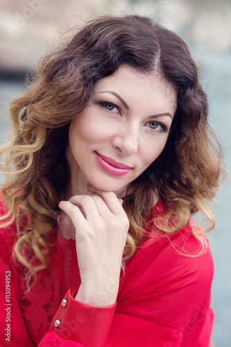 young woman in a red dress posing