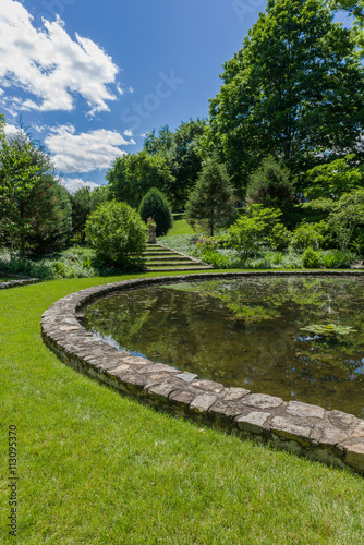 Fototapeta Naklejka Na Ścianę i Meble -  View of pond surrounded by stones at Bamboo Brook Outdoor Education Center in Chester Township, NJ