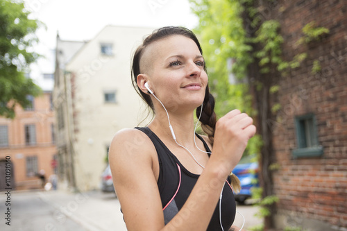 Young female runner in old city center