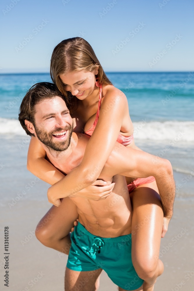 Man giving piggy back ride to woman Man giving piggy back ride to woman