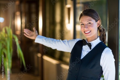 Portrait of smiling waitress welcoming