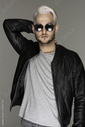 Portrait of young handsome sexy bearded man in leather jacket an