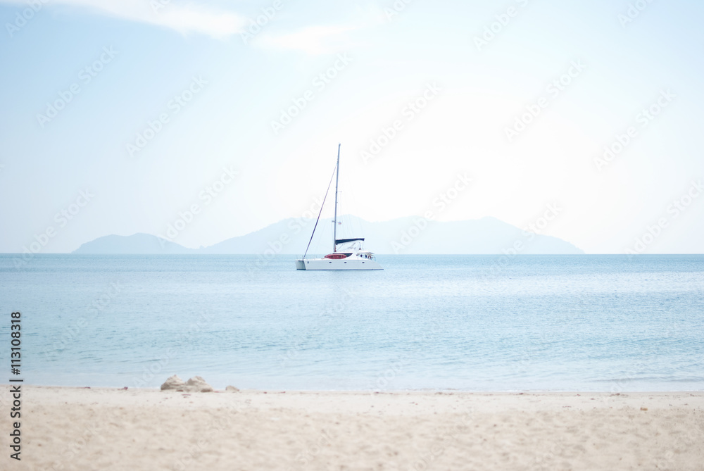 white sailboat in the sea and hot summer sunny day