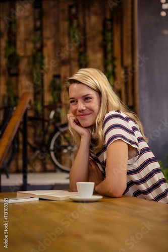 Woman sitting at a table sitting and smiling