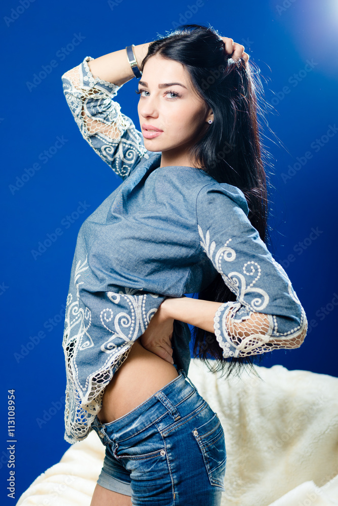 portrait of beautiful young lady posing on blue light copy space background