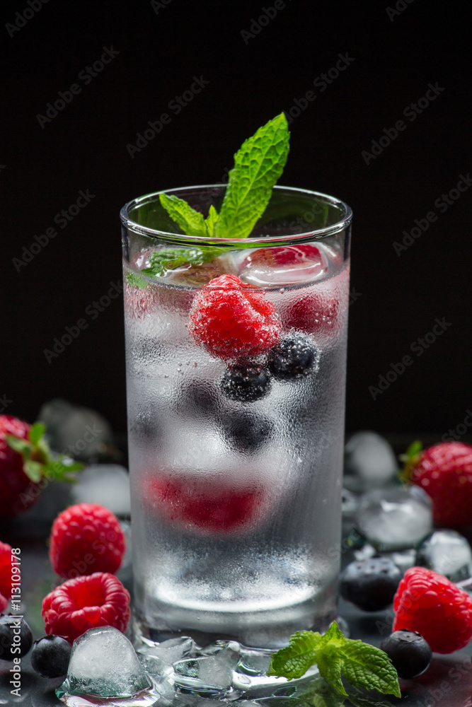 Mineral water with berries and ice cubes. Mineral water with berries and ice cubes.
