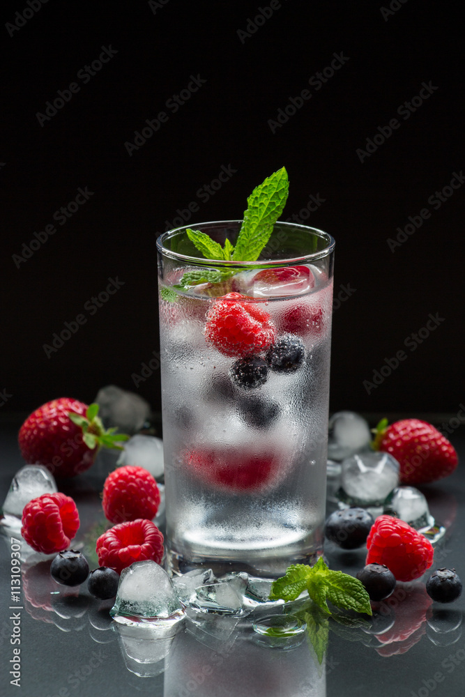 Mineral water with berries and ice cubes. Mineral water with berries and ice cubes.