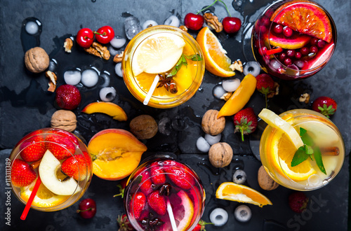 Beautiful colorful fresh cocktails with fruits and ice