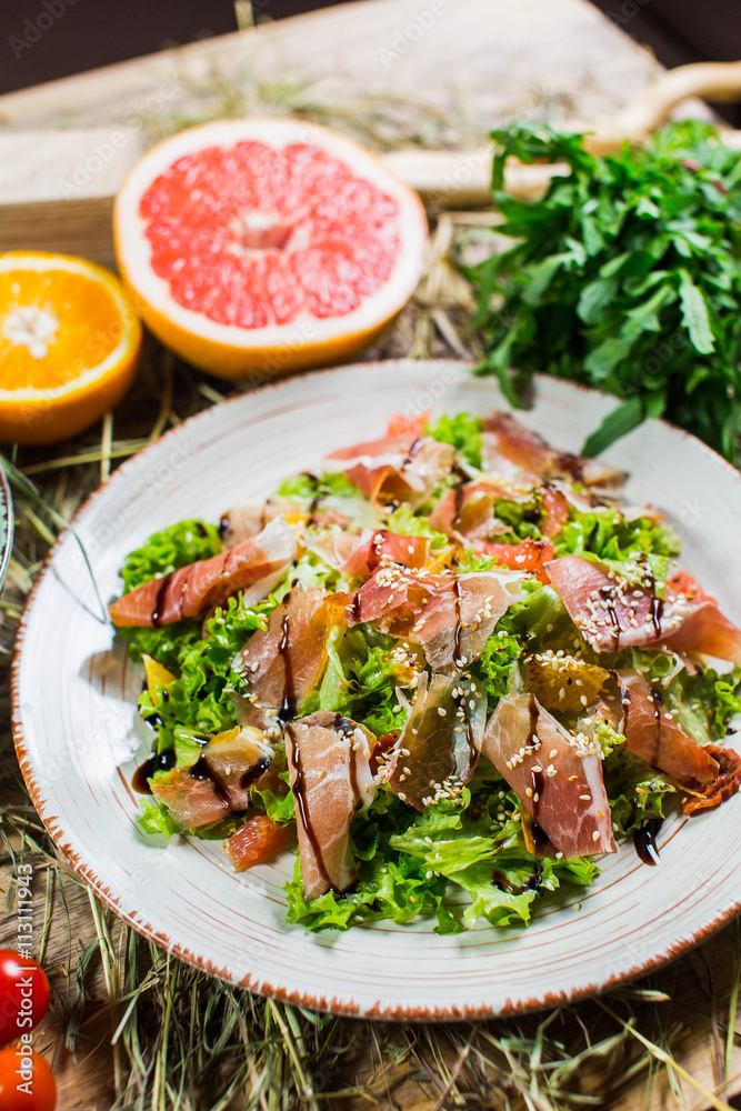 Beautiful fresh salad with lettuce, tomatoes, ham and Parmesan Beautiful fresh salad with lettuce, tomatoes, ham and Parmesan