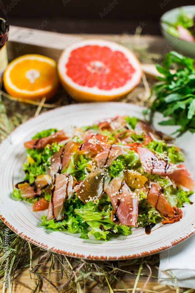 Beautiful fresh salad with lettuce, tomatoes, ham and Parmesan Beautiful fresh salad with lettuce, tomatoes, ham and Parmesan