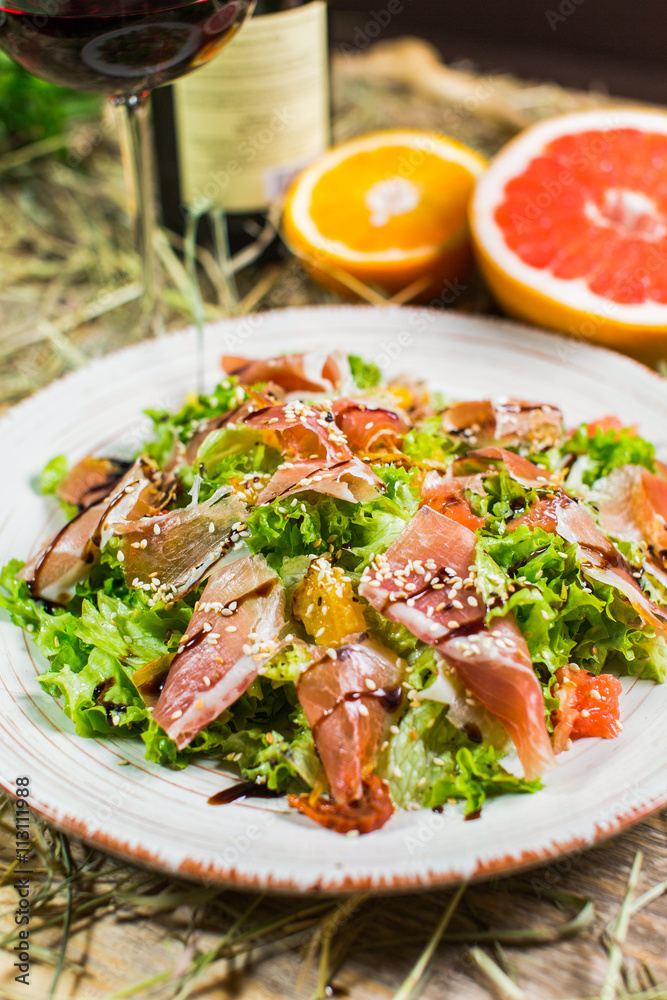 Beautiful fresh salad with lettuce, tomatoes, ham and Parmesan Beautiful fresh salad with lettuce, tomatoes, ham and Parmesan