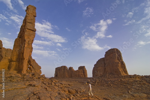 Woman walking around wonderful rock walls, Tasset, Algeria photo