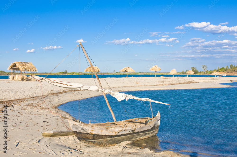 Outrigger boat lying on bank of sand, Antsanitian Beach Resort, Mahajanga, Madagascar Outrigger boat lying on bank of sand, Antsanitian Beach Resort, Mahajanga, Madagascar