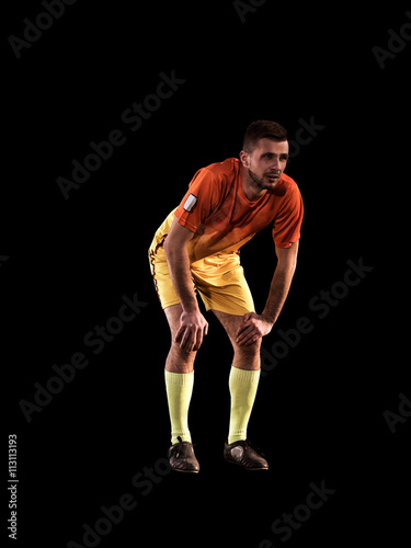 One soccer football player young man on black background