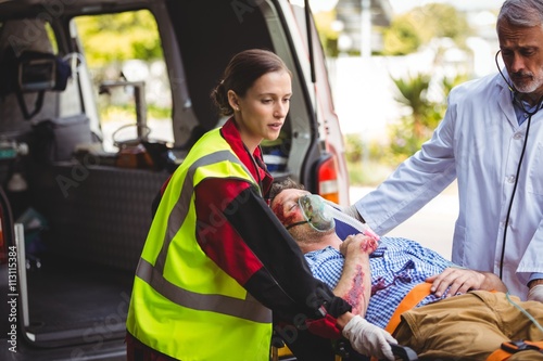 Ambulance crew and doctor taking care of an injured person
