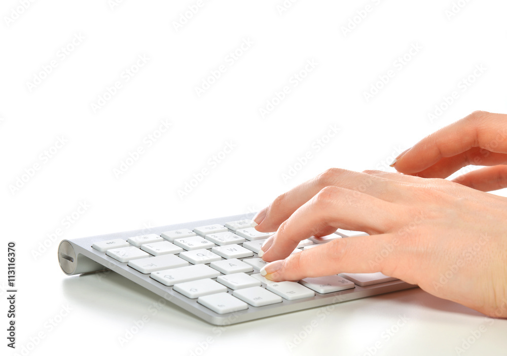 Hands typing on the remote wireless computer keyboard Hands typing on the remote wireless computer keyboard