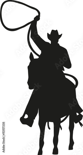 Cowboy with lasso on a horse silhouette