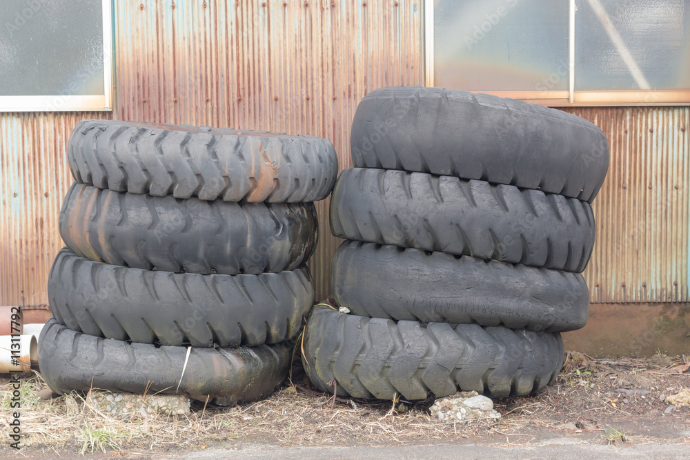 pile of old tires and wheels for rubber recycling in countryside Stock