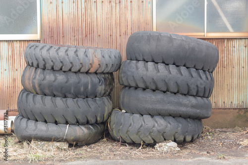 pile of old tires and wheels for rubber recycling in countryside