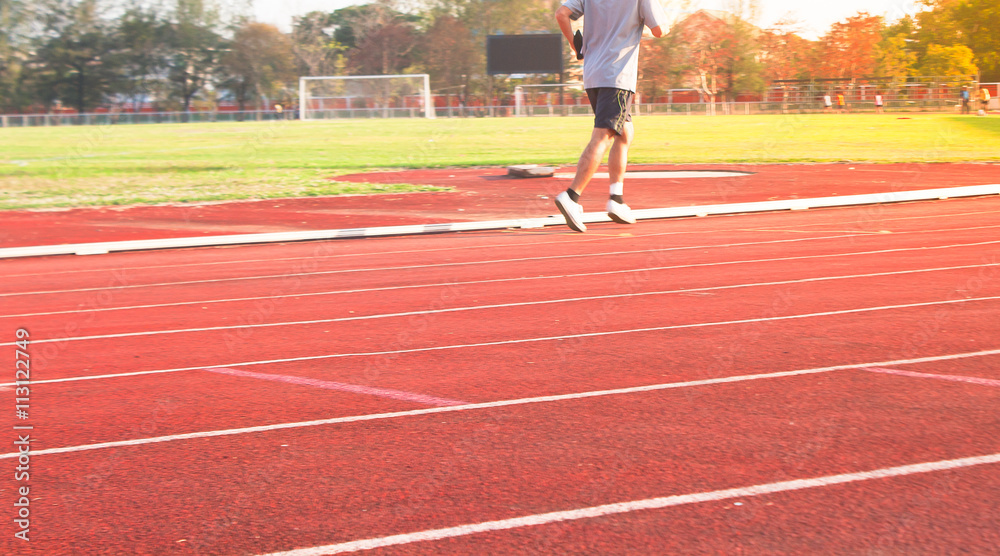 Obraz premium Healthy Living Concept. Man running in field Motion blur, Sunset time.