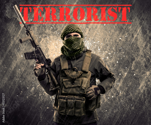 Εκτύπωση καμβά Dangerous masked and armed man with terrorist sign on grungy bac