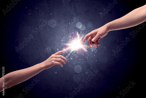 Hands reaching to light a spark © ra2 studio