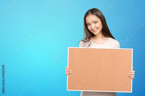 Young dark hair woman keeping cork board