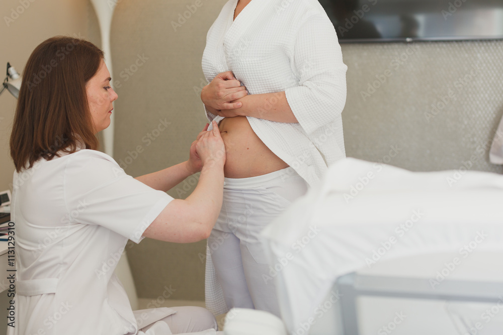Naklejka premium Surgeon, liposuction, body.Overweight, obesity, fat woman, fat belly, hips and excess weight. cellulite, stretching