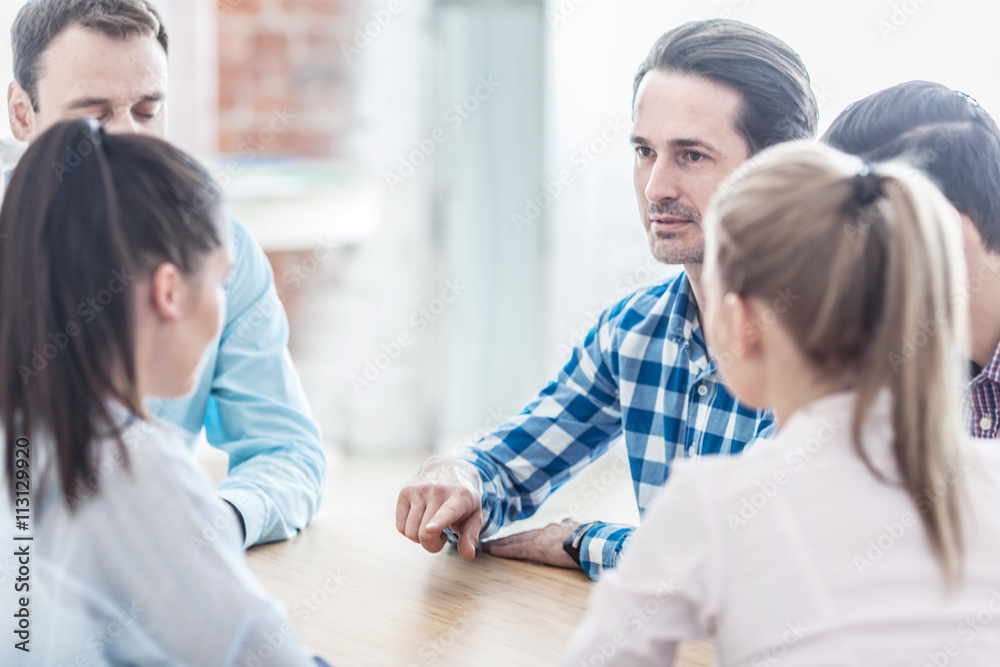Business team talking at meeting table Business team talking at meeting table