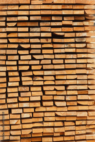 Stacked of wood log for construction buildings background and texture