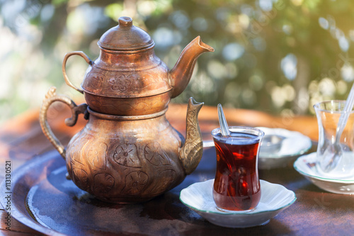 Drinking Traditional Turkish Tea with Turkish tea cup and copper