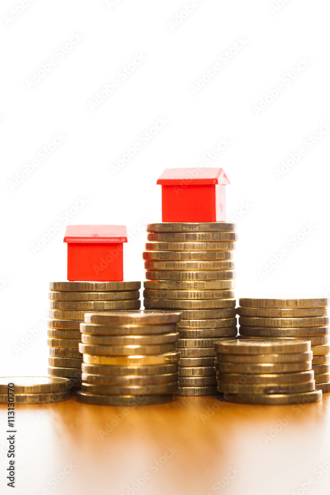 Stacks of coins, green and red home. Mortgage concept by money house from coins Stacks of coins, green and red home. Mortgage concept by money house from coins