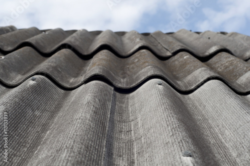 Old slate roof and blue sky. Vertical image.
