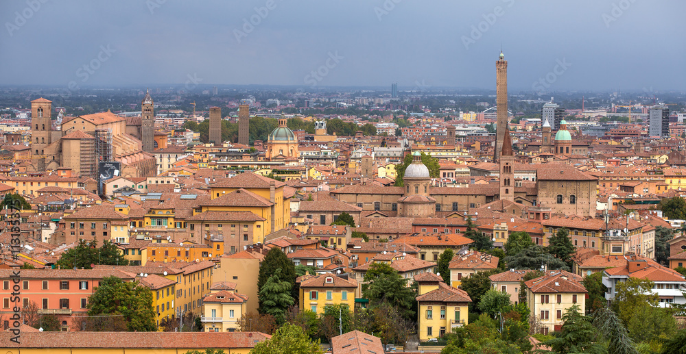 Aerial view of red tiled rooftops and ancient towers in historical center of Bologna, Italy
