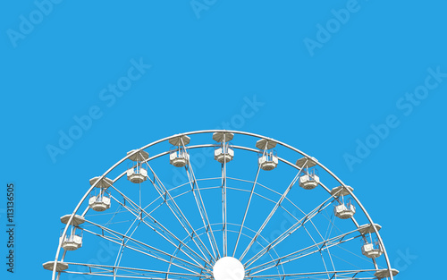 Ferris wheel against blue sky.