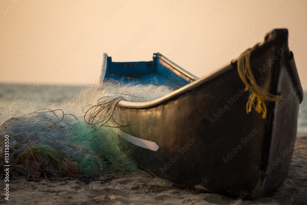 Fisherman boat with fishing nets on the Gokarna beach near the