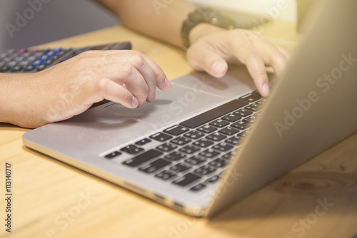 Man using, working on laptop working on blank screen laptop comp
