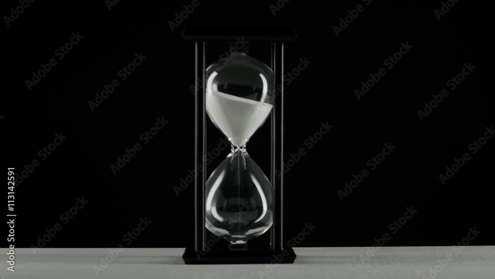 Isolated hourglass. Hourglass with white sand. Black