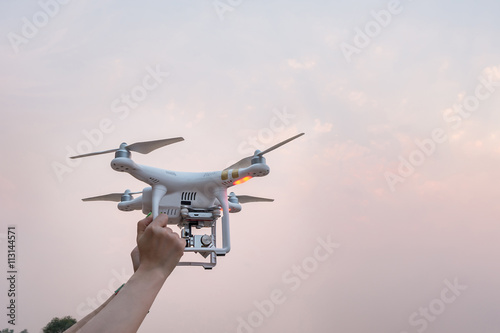 Woman Hand holding Drone at sunset